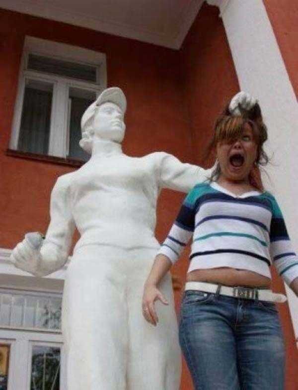 people posing with a statue