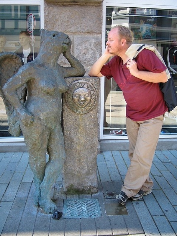 people posing with a statue